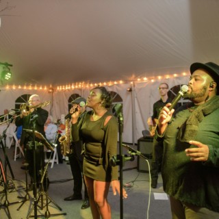 Live band performing under warm lights at an elegant wedding reception in Waterville Valley.