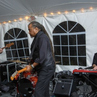 Live wedding band performing under warm tent lights in Waterville Valley, New Hampshire.