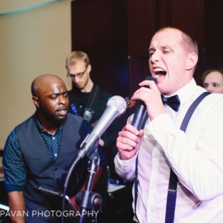 Two male vocalists perform with a live wedding band at Hyatt Regency Boston Harbor.