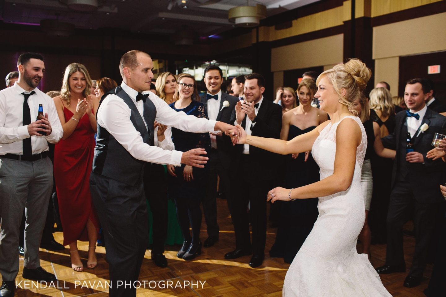 Bride and groom share first dance surrounded by guests at Boston Harbor wedding reception.