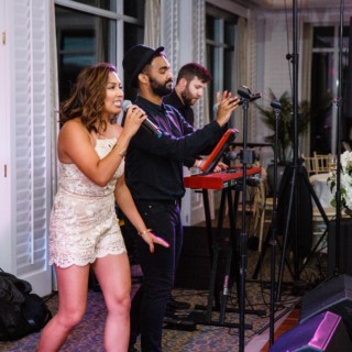 Energetic live band performing at elegant indoor wedding reception in Mashpee, Massachusetts.