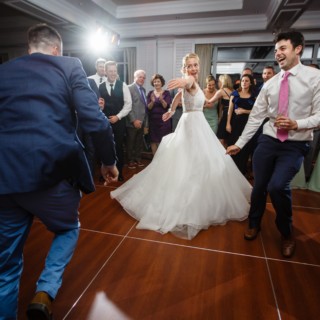 Bride dancing joyfully with guests at Willowbend Country Club wedding reception in Mashpee, Massachusetts.