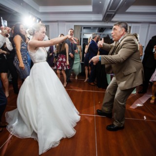 Bride dances joyfully with her father at lively Willowbend Country Club wedding in Mashpee.