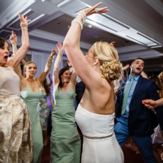 Bride dancing joyfully with guests at elegant Willowbend Country Club wedding in Mashpee, Massachusetts.