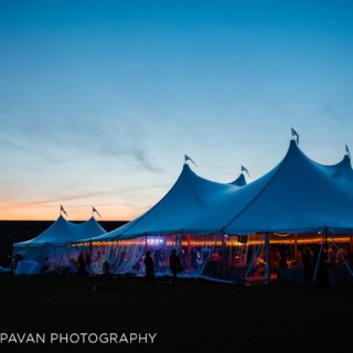 Sunset wedding tent glowing at Fort Adams in Newport, Rhode Island.