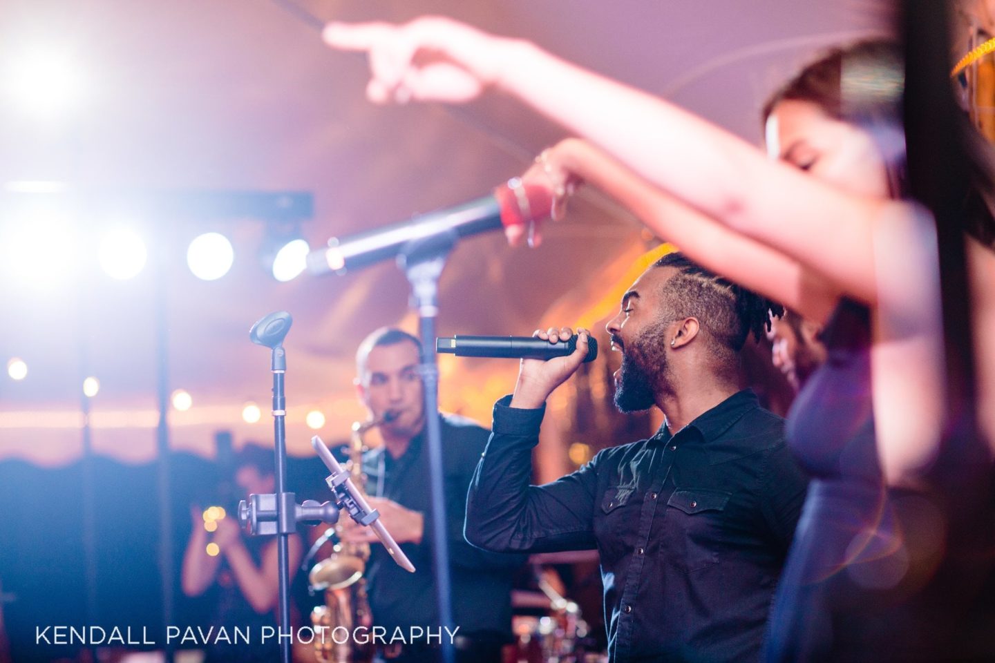 Saxophonist performing live under warm lights at a festive outdoor wedding in Newport, Rhode Island.