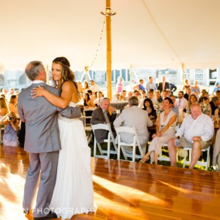 Bride dances with her father under a white tent at an elegant Newport wedding.