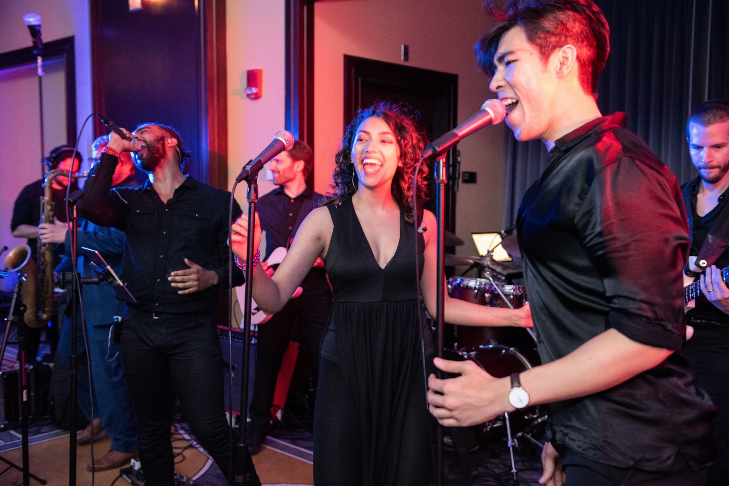 Live wedding band performing with vibrant lights at Boston’s Liberty Hotel reception.