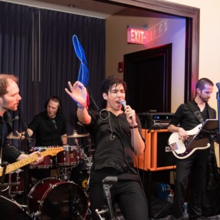 Energetic live wedding band performing at Boston’s Liberty Hotel with passionate singer and musicians.