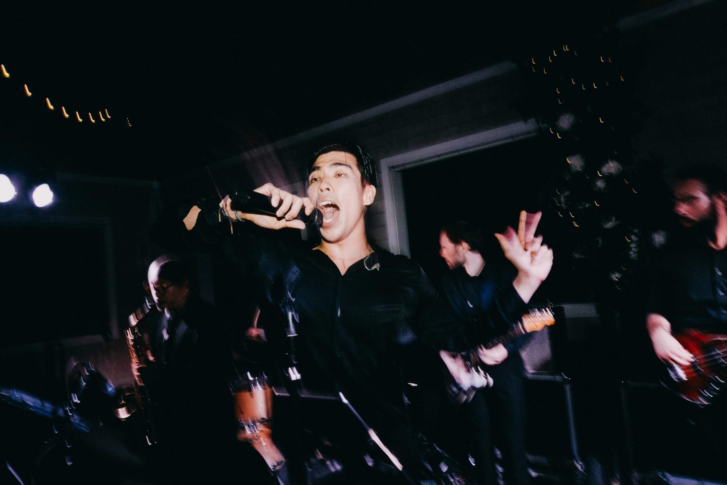 Golden sunset over Boston Harbor with skyline silhouette, calm water, and a peaceful waterfront scene.