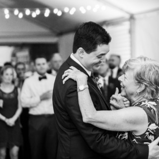 Groom dancing with his mother under string lights at Elm Bank wedding in Wellesley, Massachusetts.