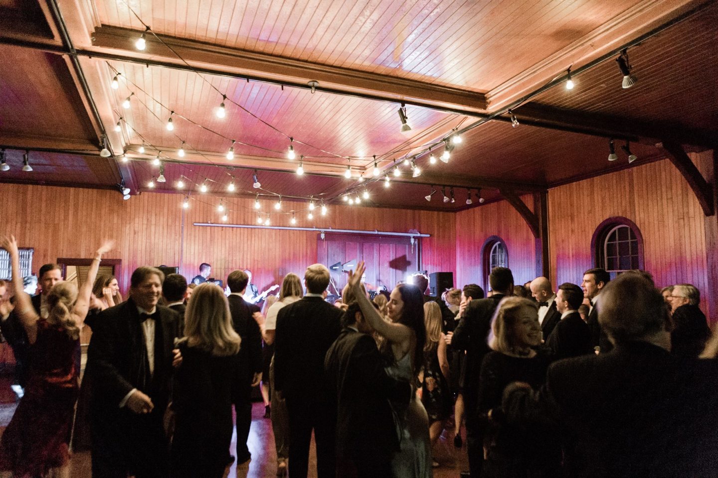 Bride and groom share a joyful first dance at their elegant Shelburne Farms wedding.