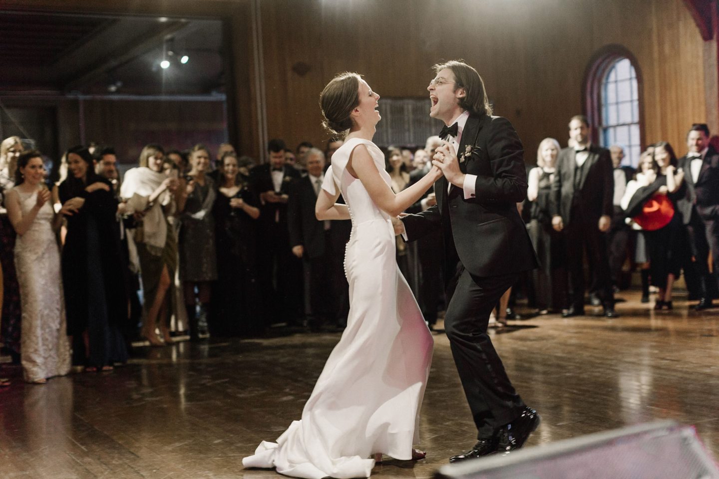 Bride and groom share a joyful first dance at their elegant Shelburne Farms wedding.