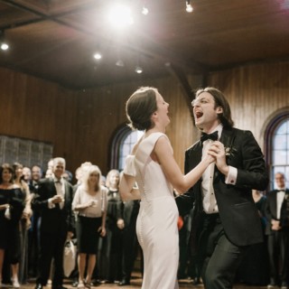 Bride and groom share a joyful first dance at rustic Shelburne Farms wedding in Vermont.