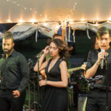 Live wedding band performing under string lights at Twin Lake Village in New London, New Hampshire.