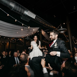 Bride and groom lifted during joyful Hora dance at Rivermill Dover wedding celebration.