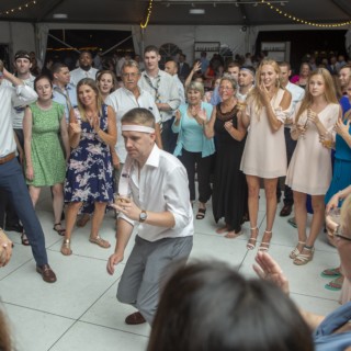 Man dancing joyfully at lively Granite Links Golf Club wedding reception in Quincy, Massachusetts.