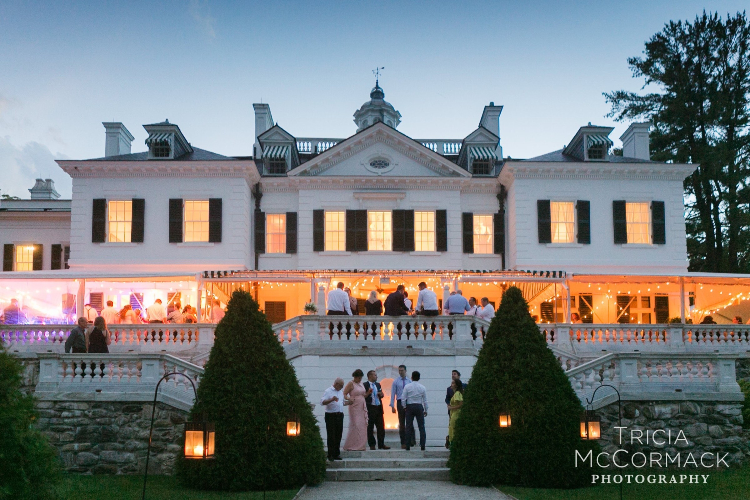 Elegant twilight wedding celebration at The Mount mansion in Lenox, Massachusetts.