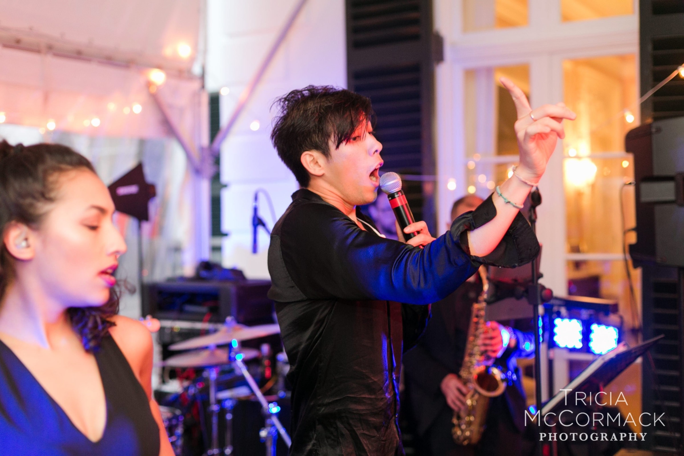 Energetic wedding band performing live under warm lights at The Mount in Lenox, Massachusetts.