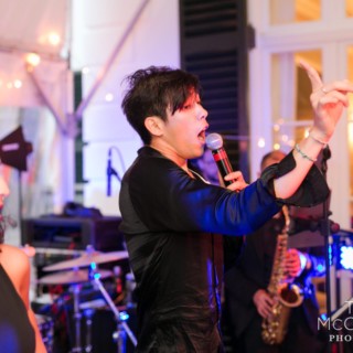 Energetic wedding band performing live under warm lights at The Mount in Lenox, Massachusetts.