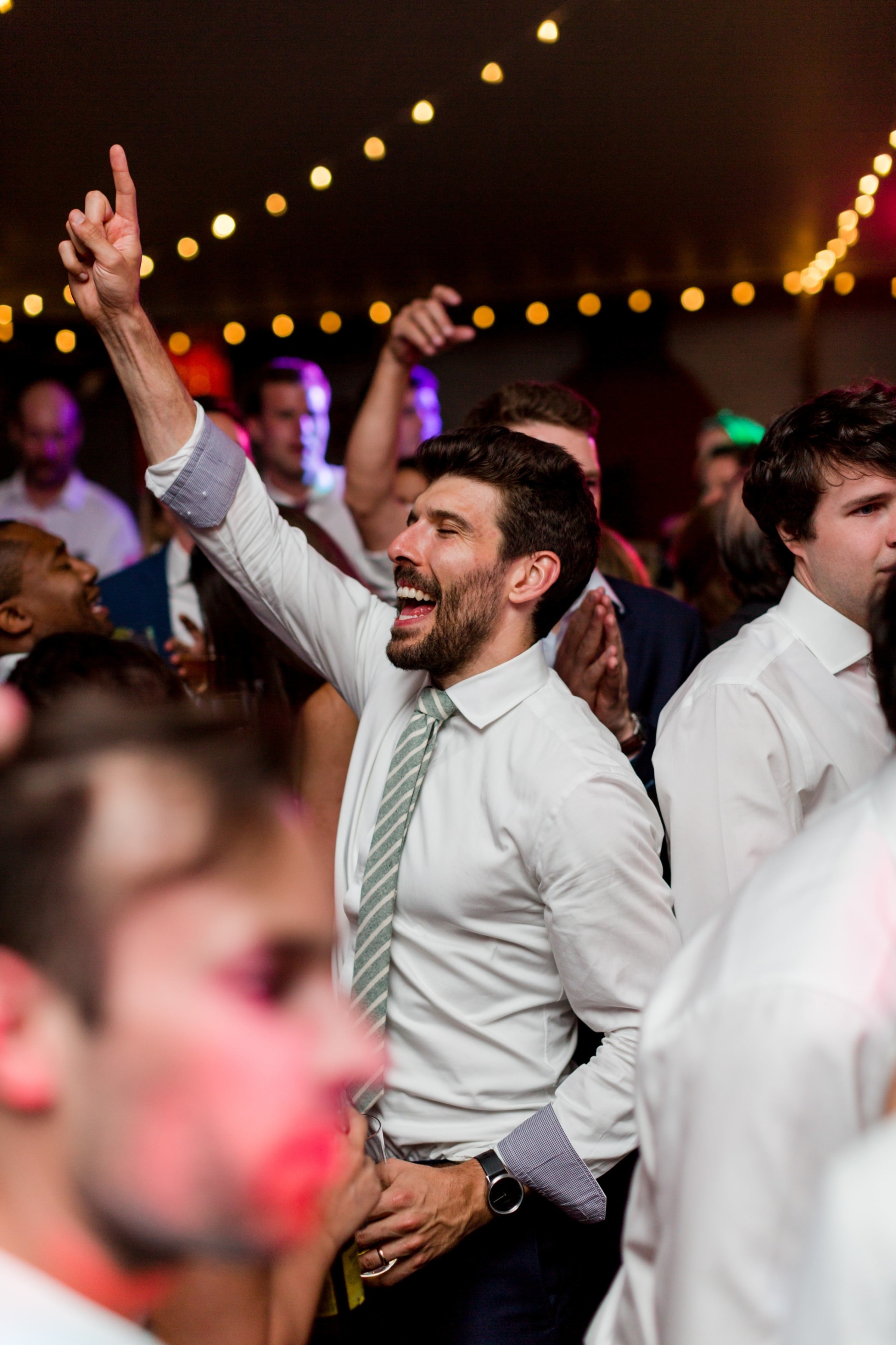 Groom celebrating joyfully on the dance floor at Twin Lakes Village wedding in New London.
