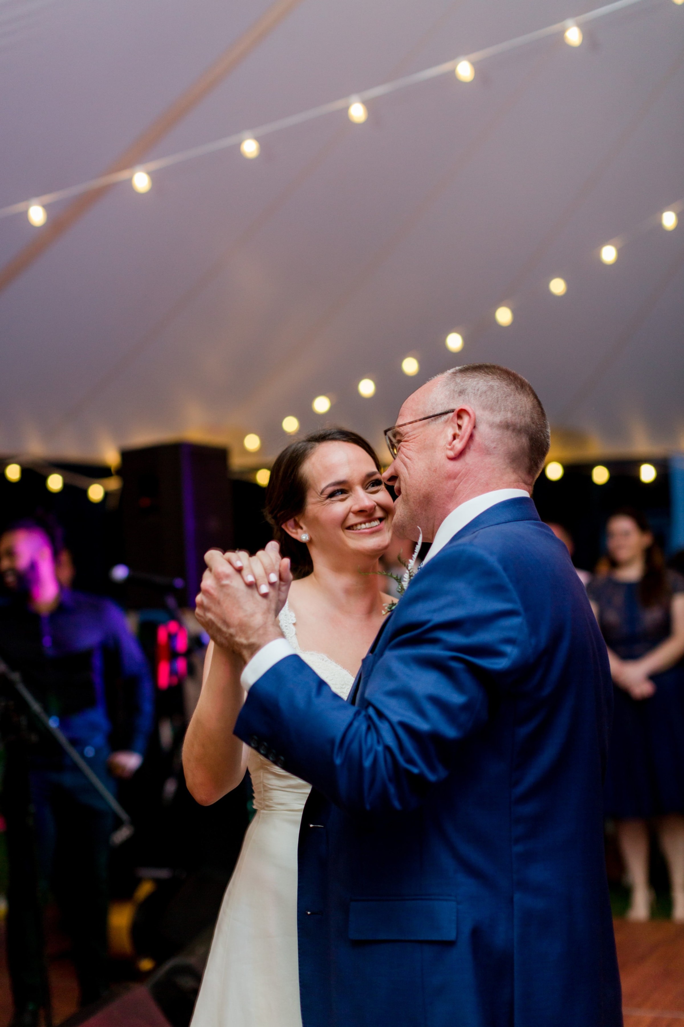 Bride and father share joyful dance under warm lights at Twin Lakes Village wedding in New London.