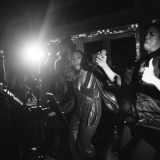 Energetic live band performance at West Dennis Yacht Club with passionate singers under bright stage lights.