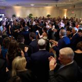 Bride and groom dancing surrounded by joyful guests at elegant Newport Marriott wedding reception.