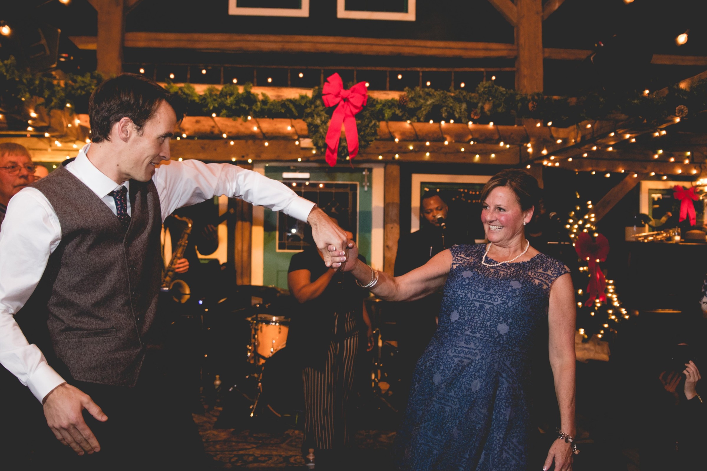 Smiling couple dancing at festive Stone Mountain Arts Center wedding in Brownfield, Maine.