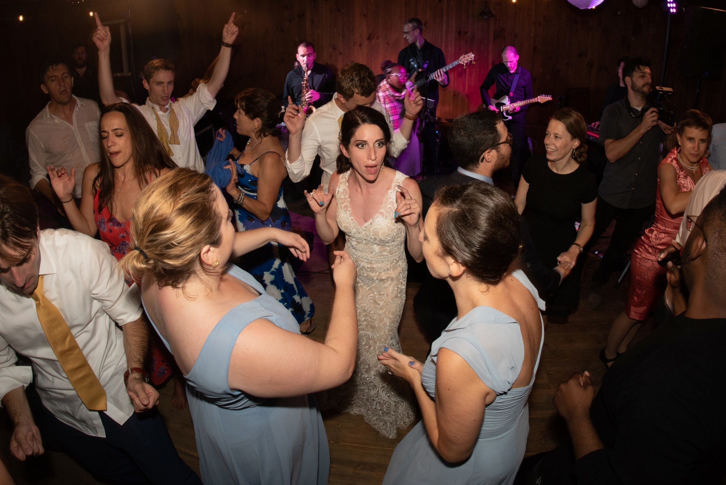 Bride dancing joyfully with guests at Chequessett Club wedding reception in Wellfleet, Massachusetts.