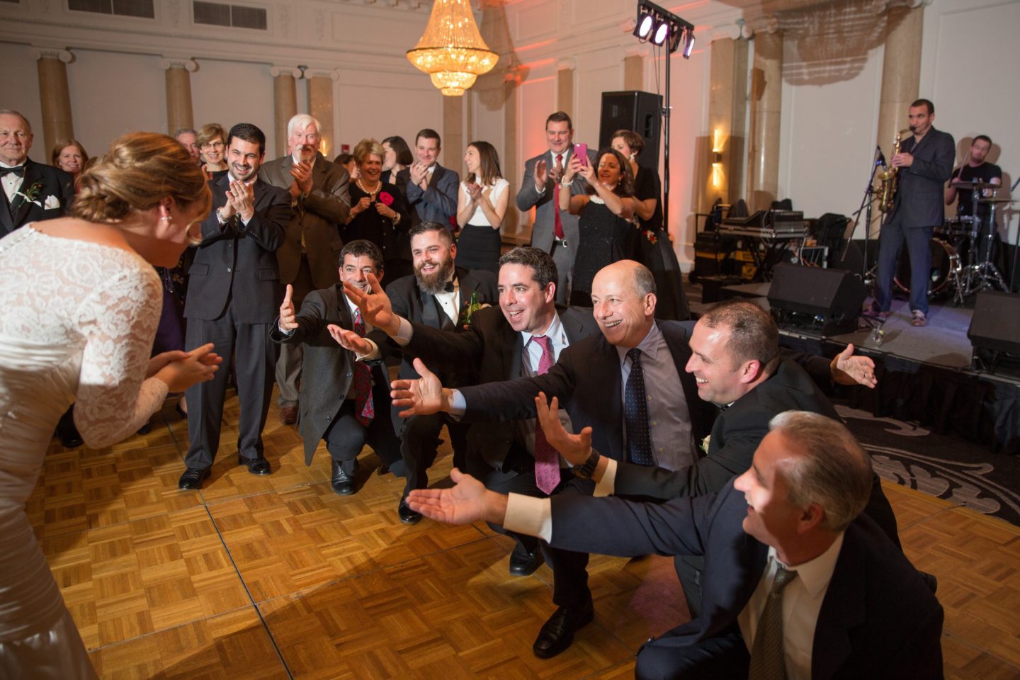 Bride and groom share first dance in elegant black-and-white Boston wedding ballroom.