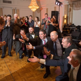 Bride and groomsmen share a joyful dance at Courtyard by Marriott Boston wedding.