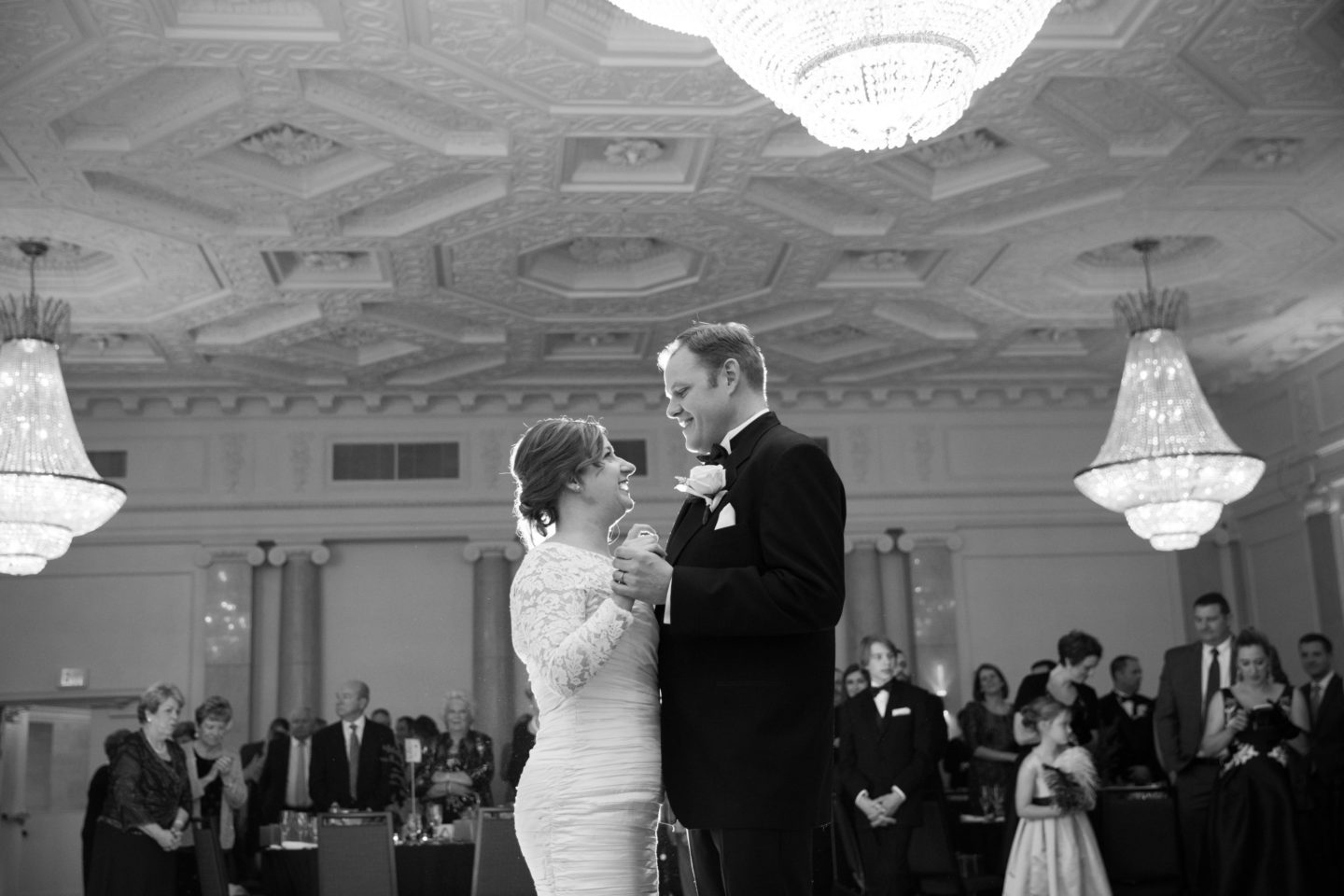 Bride and groom share first dance in elegant black-and-white Boston wedding ballroom.