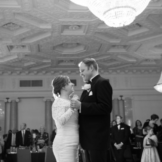 Bride and groom share first dance in elegant black-and-white Boston wedding ballroom.