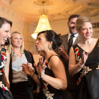 Guests celebrating joyfully at an elegant Courtyard by Marriott Boston Downtown wedding reception.