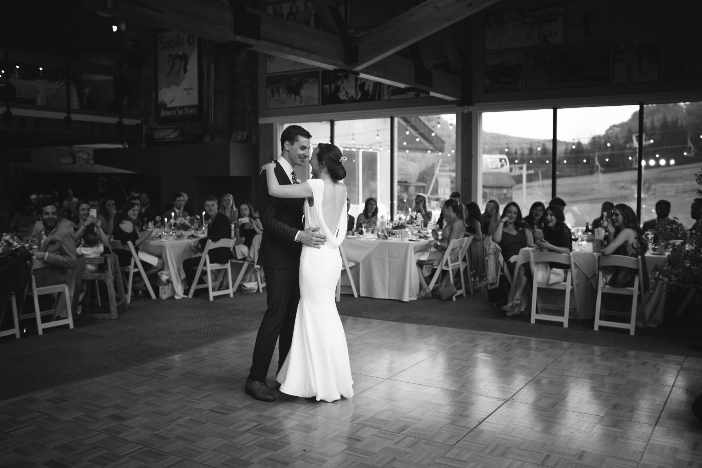 Bride and groom share first dance at rustic Vermont wedding reception.
