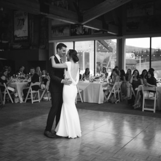 Bride and groom share first dance at rustic Vermont wedding reception.