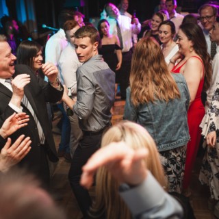 Guests dancing joyfully at a colorful wedding reception in Pomfret, Vermont.