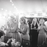 Bridesmaids laughing and clapping during a joyful wedding reception at Willowdale Estate in Massachusetts.