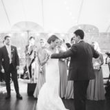 Bride and groom share a joyful first dance under romantic string lights at Willowdale Estate wedding.