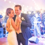 Bride and father share a joyful dance under glowing lights at Willowdale Estate wedding.