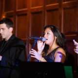 Female singer and saxophonist performing at elegant holiday wedding reception in Boston.