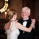 Father and daughter share a joyful dance under warm golden lights at an elegant Boston wedding.
