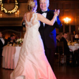 Bride and father share a joyful dance at elegant holiday wedding reception in Boston.