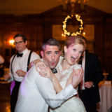 Joyful bride and groom dancing at elegant Harvard Club wedding reception in Boston.