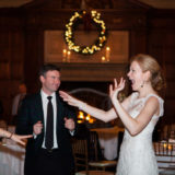 Joyful bride laughing during elegant Harvard Club wedding reception in Boston.