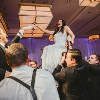 Bride lifted during joyful Hora dance at InterContinental Boston wedding celebration.