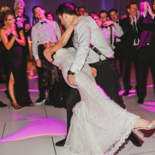 Bride and groom share a romantic dip on the dance floor at InterContinental Boston wedding.