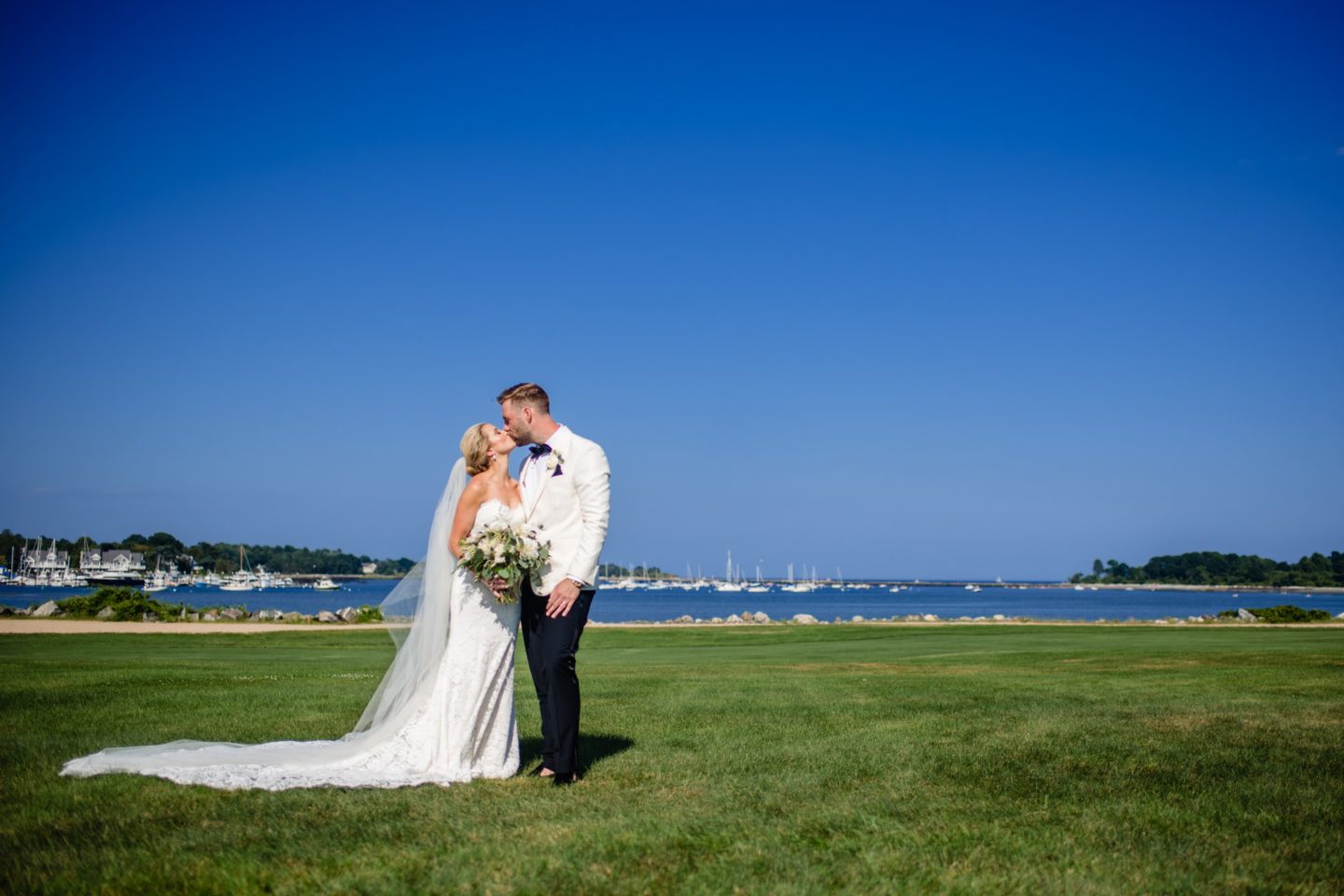 Bride and groom share a romantic seaside kiss at Wentworth by the Sea, Rye, New Hampshire.