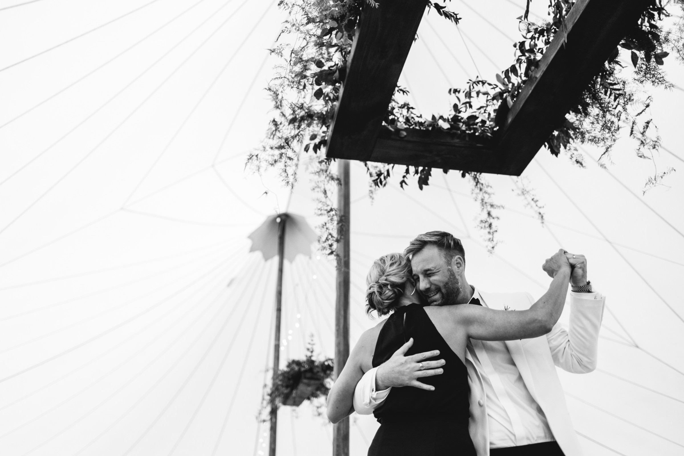 Black and white wedding photo of a couple’s emotional first dance at Wentworth by the Sea.